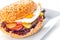 Delicious original american hamburger with grilled beef, egg and vegetables on white plate, snack or lunch, product photography fo