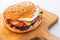 Delicious original american hamburger with grilled beef, egg and vegetables on white plate, snack or lunch, product photography fo