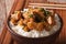 Delicious oyakodon and rice close-up in a bowl. horizontal