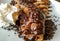 Delicious pancake crepe filled with chocolate and chocolate topping and crumbs and whipped cream as tasty dessert cheat caloric