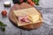 Delicious pancakes with ham and cheese on wooden board, concrete gray stone table background. Top view homemade breakfast. Russian