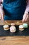 A delicious pasta dessert - a French sweet delicacy lies on a concrete black stand and a girl with a knife and fork cuts sweets