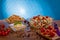 Delicious pasta salad or Mediterranean salad. Tomatoes with mozzarella basil corn spice and olive oil on a wooden table.