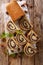 Delicious pastry poppy roll with raisins, nuts decorated with mint close-up on a table. Vertical top view