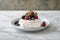 Delicious Pavlova cake with meringue topped and fresh berries on white marble.