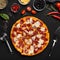 Delicious pepperoni pizza, tools and cooking ingredients