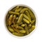 Delicious pickled cornichons in a ceramic bowl isolated on white background. Whole green gherkins marinated with dill and mustard