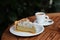 Delicious piece of lemon pie and coffee