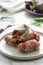 Delicious pigs in blankets, meat wrapped in bacon, homemade cooked meat bites. Bright food photo