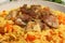 Delicious pilaf with meat in white bowl, closeup