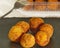 Delicious Pincho of several round croquettes making an horizontal circle on a black slate board decorated with croquettes in a