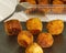 Delicious Pincho of several round croquettes making an horizontal pyramid on a black slate board decorated with croquettes in a