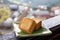 Delicious pineapple pastry in a plate for afternoon tea on wooden railing of a teahouse in Taiwan with beautiful landscape in