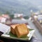 Delicious pineapple pastry in a plate for afternoon tea on wooden railing of a teahouse in Taiwan with beautiful landscape in