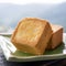 Delicious pineapple pastry in a plate for afternoon tea on wooden railing of a teahouse in Taiwan with beautiful landscape in