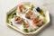 Delicious pink and white somen canapes with salted plum and prosciutto ham on a white platter, AI generated