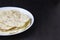 Delicious pita bread made at home in a pan. Thin pita bread on a white plate