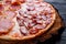 Delicious pizza with bacon, salami,ham and pepperoni and appetiz