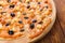 Delicious pizza with pineapple, chicken and olives