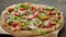 Delicious Pizza with prosciutto parma ham, arugula salad rocket and cherry tomato on rusty dark