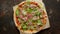 Delicious Pizza with prosciutto parma ham, arugula salad rocket on rusty dark