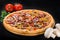 Delicious pizza with salami, beef, mozzarella, pepper and sauce