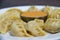 A Delicious Plate of Chicken Momo Dumpling with Yellow Chutney Nepali Food
