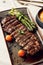 Delicious plate of Churrasco Steak, featuring with fresh asparagus and ripe tomatoes