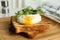 Delicious poached egg with toasted bread and sprouts served on wooden plate