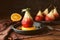 Delicious poached pear in red wine with orange slices and spices on pan