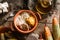 Delicious polenta with meat, cheese and sour cream in bowl on rustic wooden background. Traditional Romanian food, top view