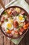 Delicious Polish soup Zurek with sausage and eggs in a bowl. Vertical top view