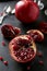 Delicious pomegranate fruit on plate on the black background