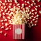 Delicious popcorn scattering from a red striped carton box on red background with copy space