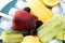 Delicious popsicle, ice cubes and fresh fruits on plate, closeup