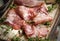 Delicious pork bacon sliced â€‹â€‹into strips on a wooden background with spices and fresh thyme. A serving of low-fat succulent