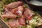 Delicious pork bacon sliced â€‹â€‹into strips on a wooden background with spices and fresh thyme. A serving of low-fat succulent