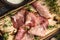 Delicious pork bacon sliced â€‹â€‹into strips on a wooden background with spices and fresh thyme. A serving of low-fat succulent