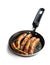 Delicious pork chipolatas sausages in a frying pan isolated on white