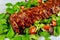 Delicious pork ribs with green salad and tangy BBQ sauce
