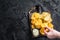 Delicious Potato chips - Crinkle, homemade, hot BBQ on a wooden board. Black background. Top view. Copy space