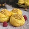 Delicious profiteroles with caramel nut cream on a ceramic plate on a dark wooden background