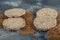 Delicious puffed crispbread and raw buckwheat on marble surface