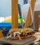 Delicious pulled pork sandwich served with a knife on a wooden plate.