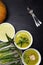 delicious pumpkin, asparagus cream soup with shrimp on dark wooden background, top view, copy space