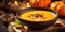Delicious pumpkin soup in bowl on wooden table. Autumn still life.
