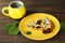 Delicious Quiche pie with cherry filling on yellow plate with cup of coffe
