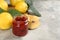 Delicious quince jam and fruits on light grey table, closeup