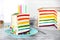 Delicious rainbow cake with candles for party