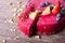 Delicious raspberry cake with fresh strawberries, raspberries, blueberry, currants and pistachios on wooden background